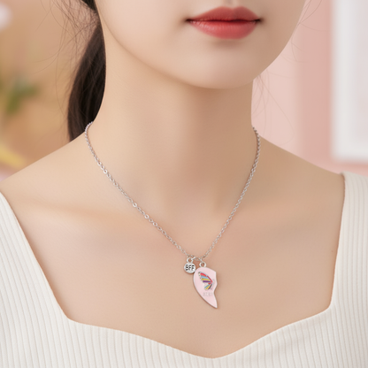 Necklace with a pink leaf-shaped pendant and 'BFF' charm worn by a person.